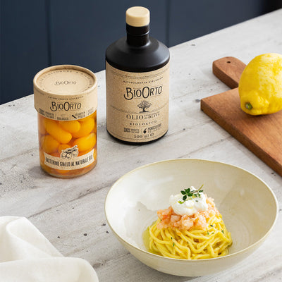 Spaghetti with yellow cherry tomatoes, red shrimp and stracciatella